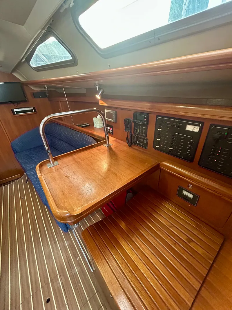 Slide: The Image of Interior of the 2005 Hunter 41 Aft Cockpit with wooden table and control panel. - 4