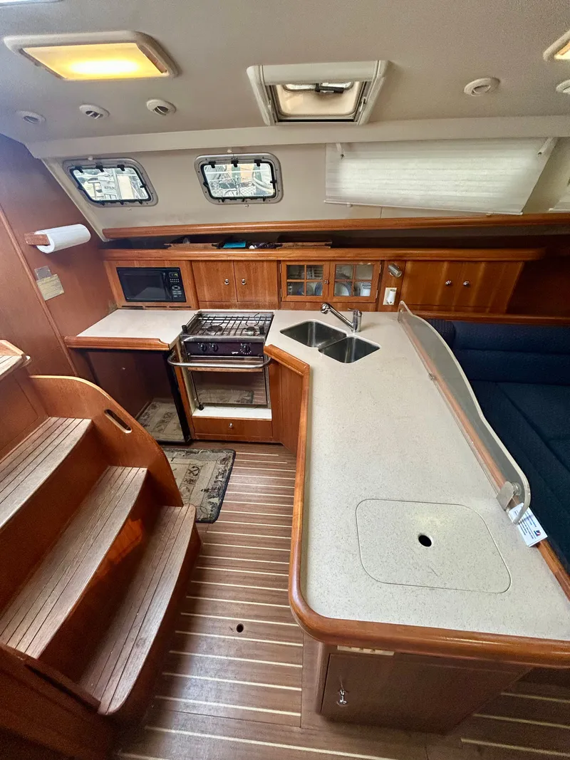 Slide: The Image of Interior of the 2005 Hunter 41 Aft Cockpit with kitchen and seating area. - 12