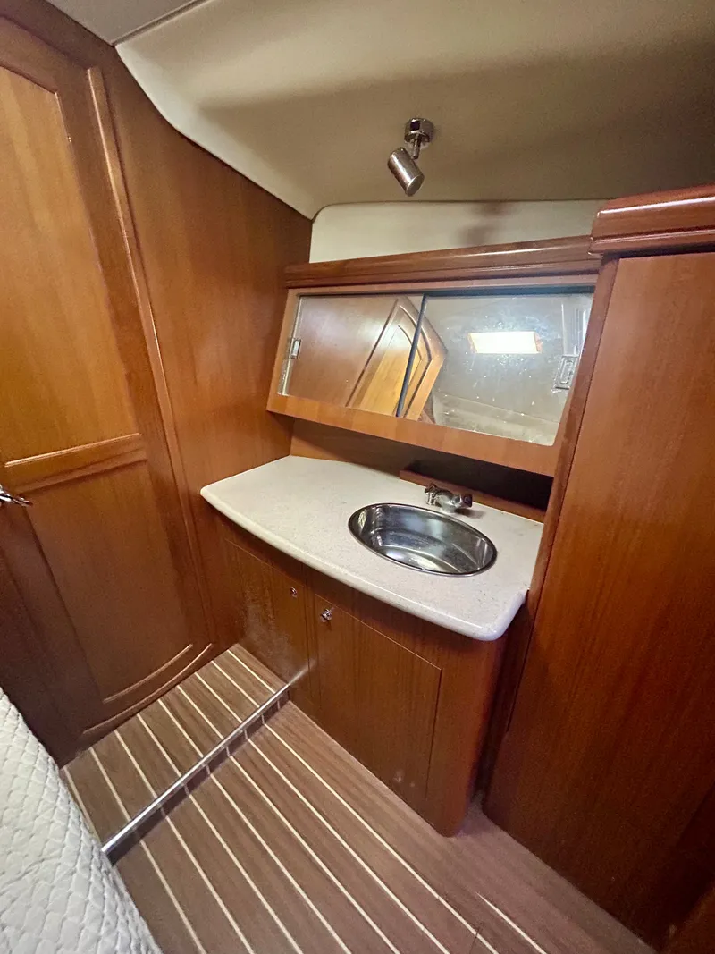 Slide: The Image of Interior of the 2005 Hunter 41 Aft Cockpit with wood paneling and a sink. - 26