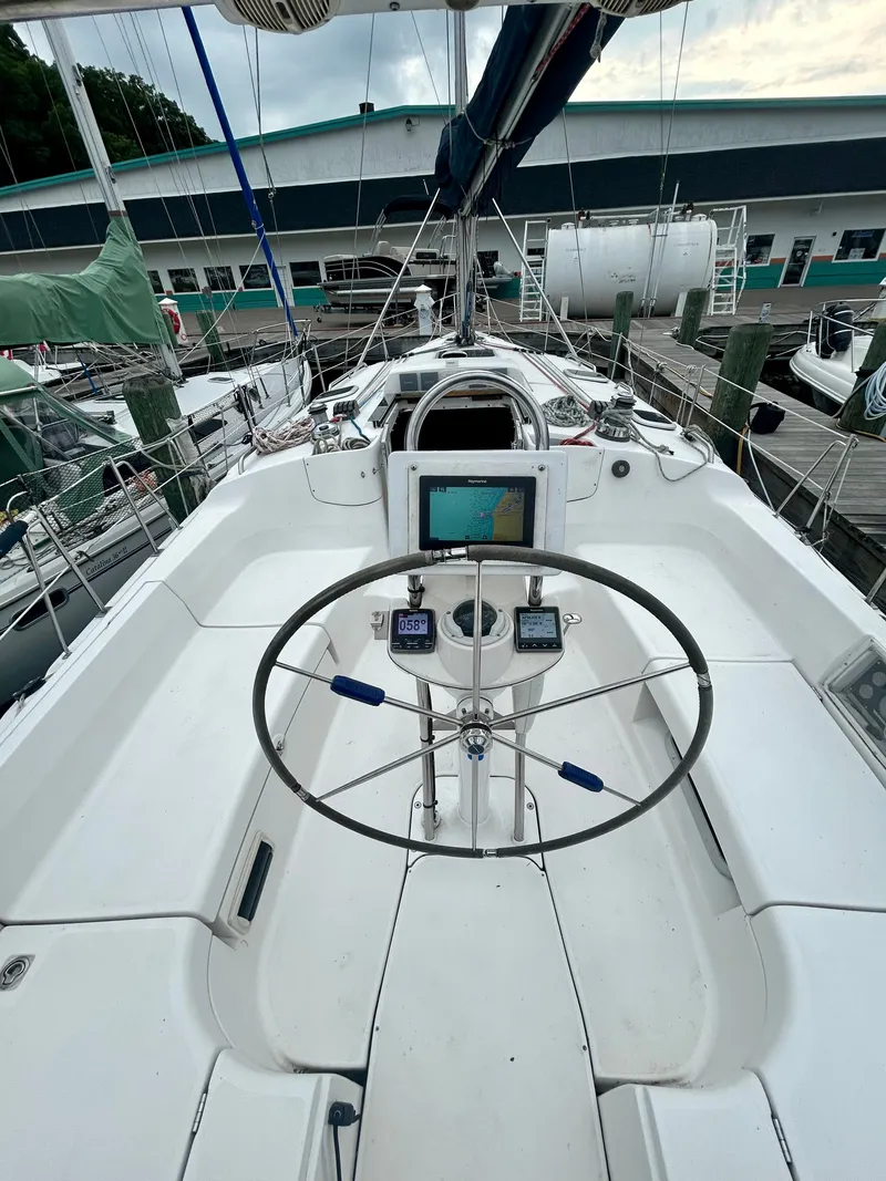 Slide: The Image of The image shows the cockpit of a 2005 Hunter 41 Aft Cockpit. It features a steering wheel and navigation instruments. - 20