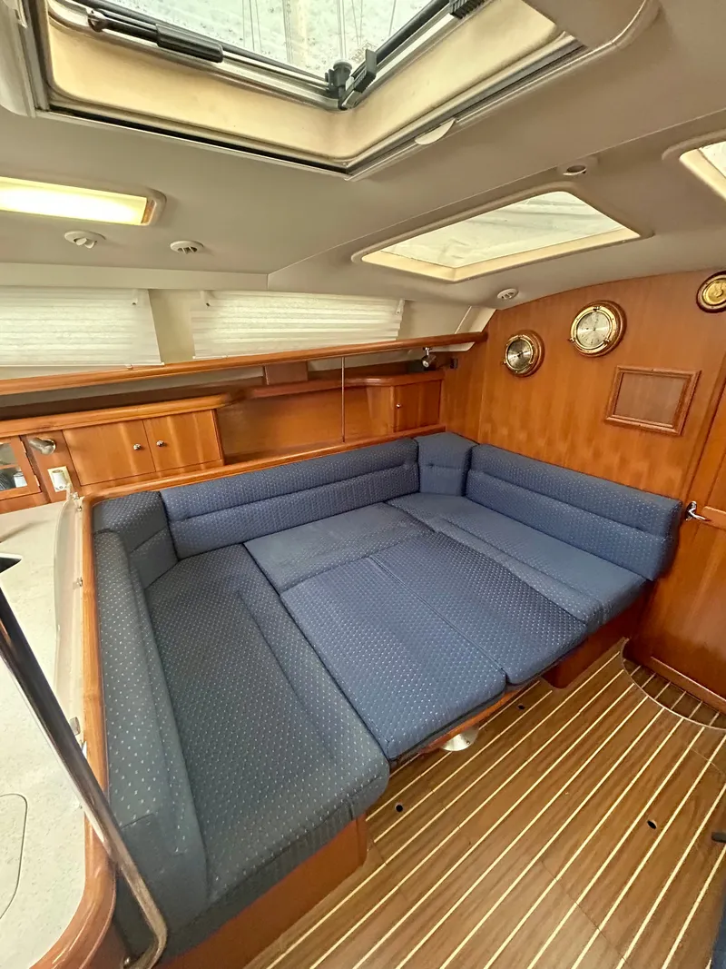 Slide: The Image of Interior of the 2005 Hunter 41 Aft Cockpit with blue upholstery and wooden walls. - 5