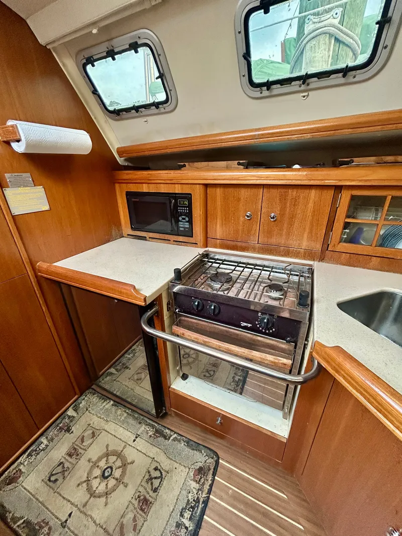 Slide: The Image of Galley of the 2005 Hunter 41 Aft Cockpit with stove, microwave, and sink. - 13