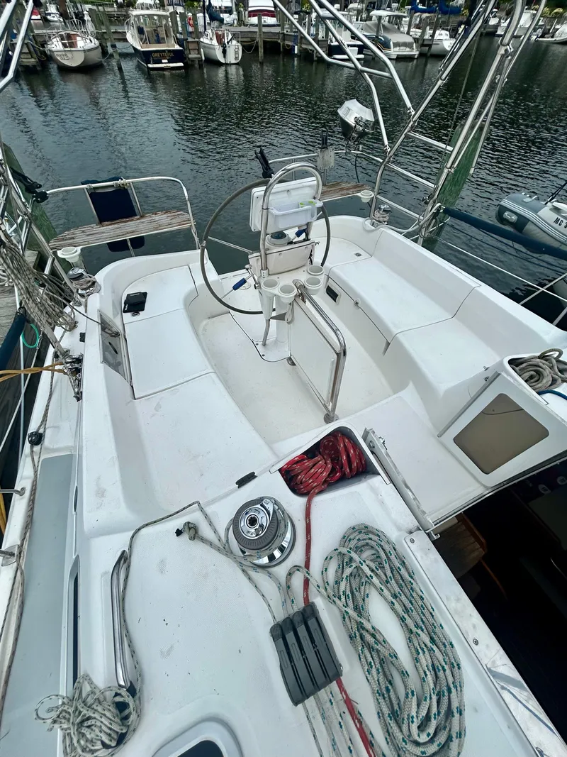 Slide: The Image of The image shows the cockpit of a 2005 Hunter 41 Aft Cockpit with a steering wheel and ropes. - 21