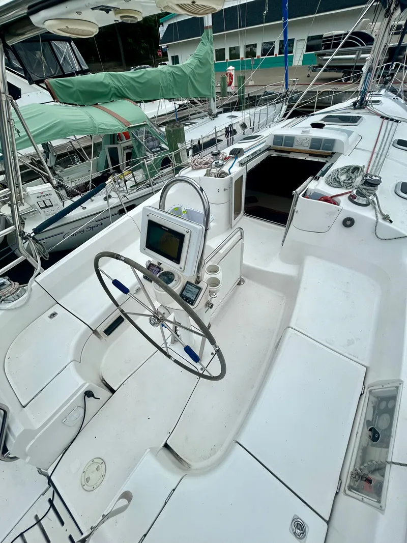 Slide: The Image of The cockpit of a 2005 Hunter 41 Aft Cockpit with a steering wheel and navigation system. - 22