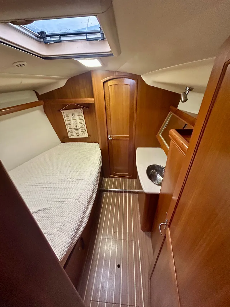 Slide: The Image of Cabin of the 2005 Hunter 41 Aft Cockpit with wood flooring, bed, and sink. - 23