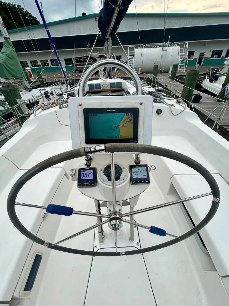 Slide: The Image of Helm of a 2005 Hunter 41 Aft Cockpit with navigation system and compass. - 19