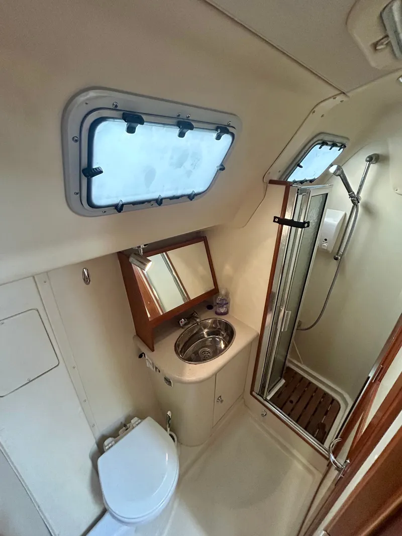 Slide: The Image of Bathroom in a 2005 Hunter 41 Aft Cockpit yacht with shower, sink, and toilet. - 8