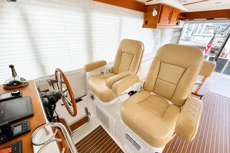 Slide: The Image of Interior of 2021 Back Cove 41 yacht with beige captain chairs and wooden accents. - 28