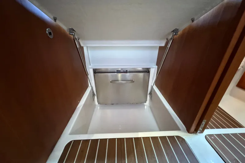 Slide: The Image of 2021 Back Cove 41 yacht interior with wooden cabinetry and built-in stainless steel appliance. - 33