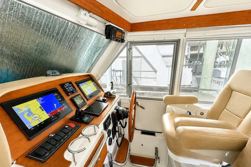 Slide: The Image of Helm of 2021 Back Cove 41 yacht with navigation screens and leather captain's chair. - 29