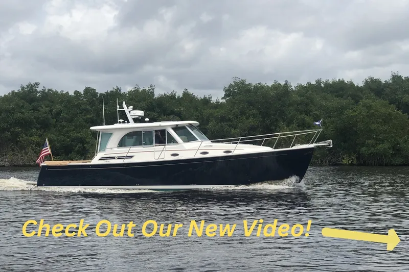 The Image of 2021 Back Cove 41 cruising on a river with promotional text overlay. - 0