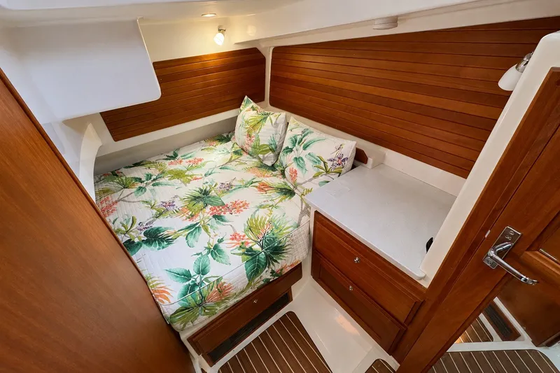 Slide: The Image of Luxurious cabin interior of 2021 Back Cove 41 yacht with floral bedding and wooden accents. - 41