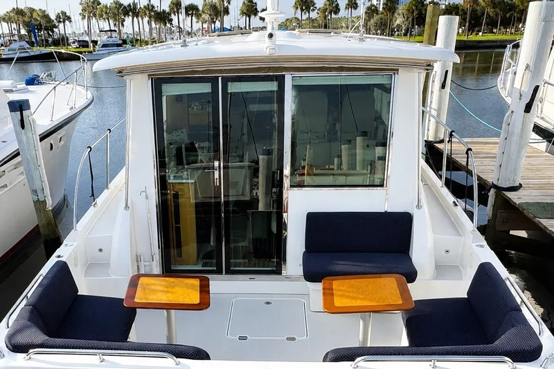 Slide: The Image of 2021 Back Cove 41 yacht with seating area and tables at marina. - 16