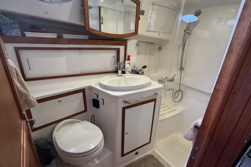Slide: The Image of 2021 Back Cove 41 yacht bathroom with sink, toilet, and shower in compact design. - 39
