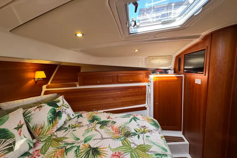 Slide: The Image of Luxurious cabin interior of 2021 Back Cove 41 yacht with floral bedding and wood accents. - 37