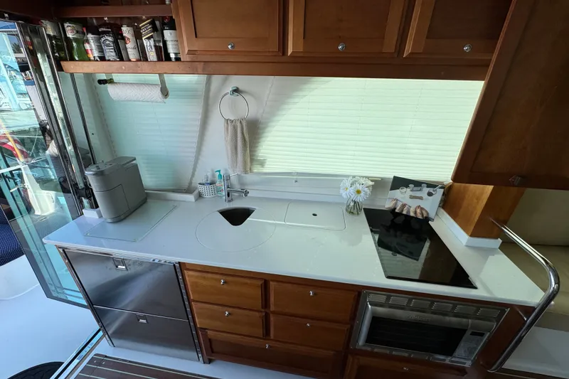 Slide: The Image of Modern kitchen in a 2021 Back Cove 41 yacht with sleek appliances and wooden cabinetry. - 23
