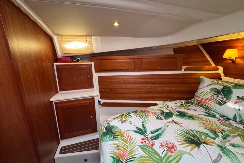 Slide: The Image of Luxurious cabin interior of 2021 Back Cove 41 yacht with tropical bedding and wooden cabinetry. - 36
