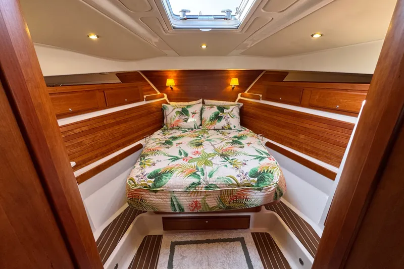 Slide: The Image of Luxurious cabin interior of 2021 Back Cove 41 yacht with tropical bedding and wood accents. - 35