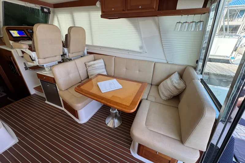 Slide: The Image of Interior of 2021 Back Cove 41 yacht with beige seating and wooden table. - 19