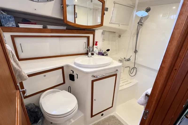 Slide: The Image of Luxurious bathroom in 2021 Back Cove 41 yacht, featuring modern fixtures and elegant wood accents. - 42