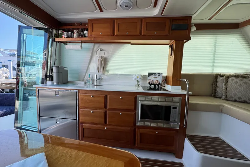 Slide: The Image of Interior of 2021 Back Cove 41 yacht featuring a modern kitchen with wooden cabinetry. - 22