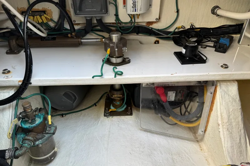 Slide: The Image of Engine compartment of a 2021 Back Cove 41 boat, showcasing mechanical components and wiring. - 13