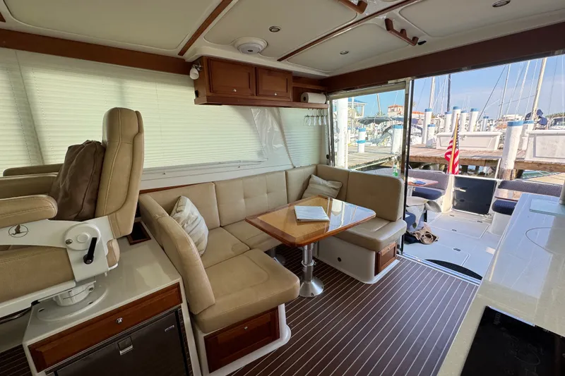 Slide: The Image of Interior of a 2021 Back Cove 41 yacht with seating and table, dockside view. - 18
