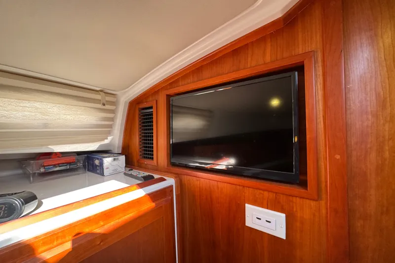 Slide: The Image of Interior of 2021 Back Cove 41 yacht featuring a mounted TV and wooden cabinetry. - 38