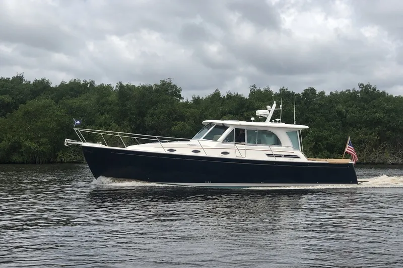 The Image of 2021 Back Cove 41 yacht cruising on a calm river under cloudy skies. - 0