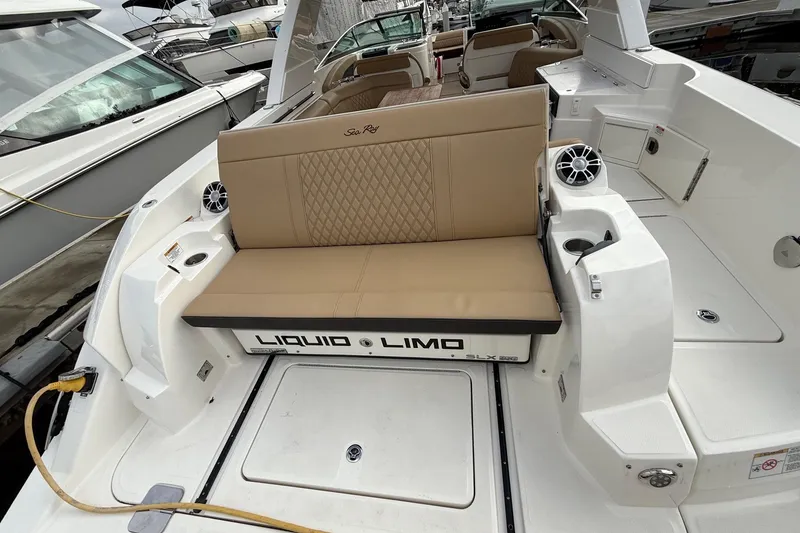 Slide: The Image of 2023 Sea Ray SLX 350 boat interior with beige seating and speaker system. - 15