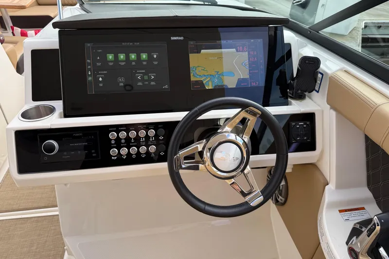 Slide: The Image of 2023 Sea Ray SLX 350 dashboard with steering wheel and navigation display. - 28