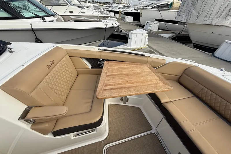 Slide: The Image of Luxurious seating area on 2023 Sea Ray SLX 350 boat with wooden table. - 35