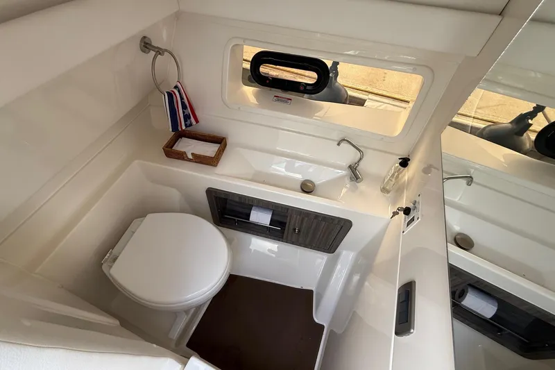 Slide: The Image of 2023 Sea Ray SLX 350 boat bathroom with modern fixtures and compact design. - 31