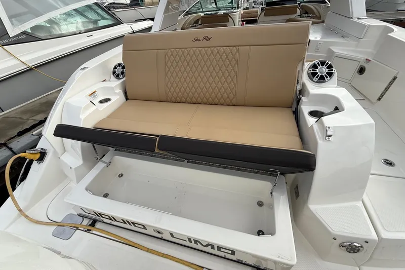 Slide: The Image of 2023 Sea Ray SLX 350 boat with tan seating and storage compartment. - 16