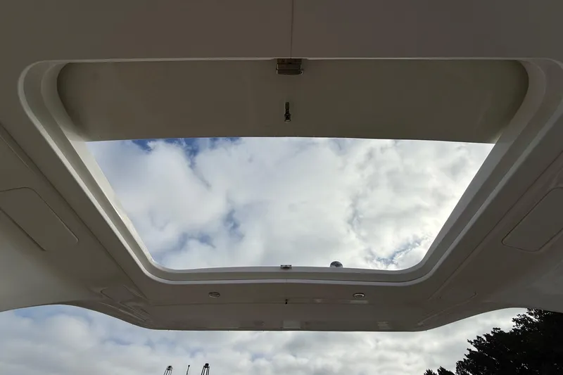 Slide: The Image of Sunroof view from 2023 Sea Ray SLX 350 boat, showcasing cloudy sky. - 13