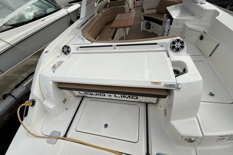 Slide: The Image of 2023 Sea Ray SLX 350 boat interior with seating and table, featuring "Liquid Limo" branding. - 17
