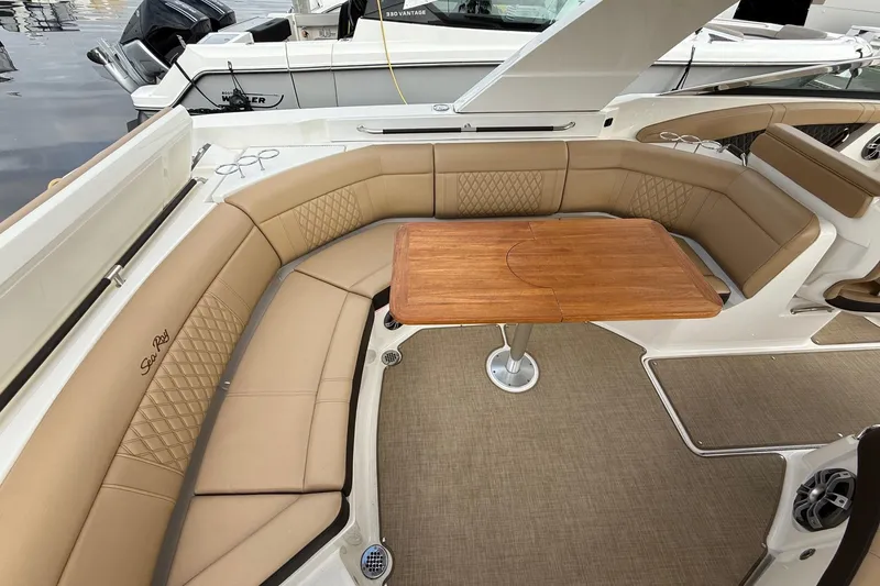 Slide: The Image of Luxurious seating area on 2023 Sea Ray SLX 350 boat with wooden table. - 20
