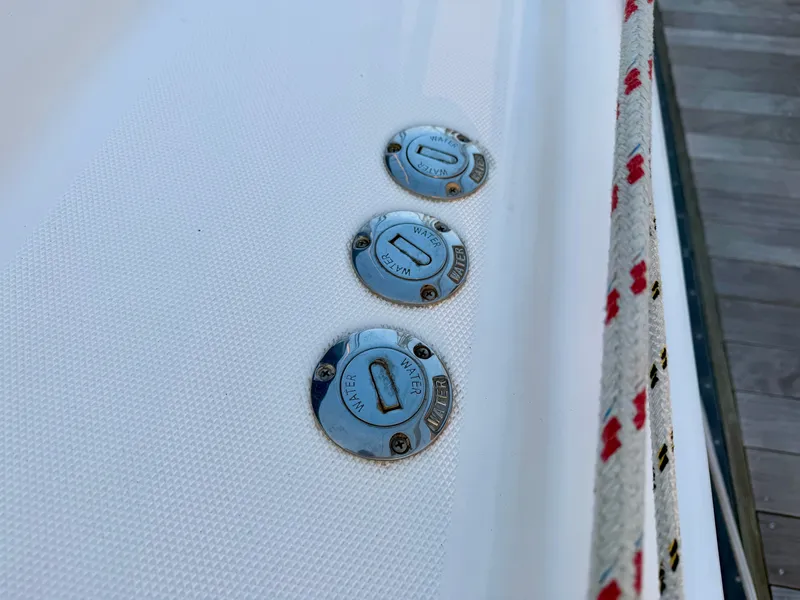 Slide: The Image of Three round metal covers on a white boat deck, labeled "Water" and "Diesel." - 33