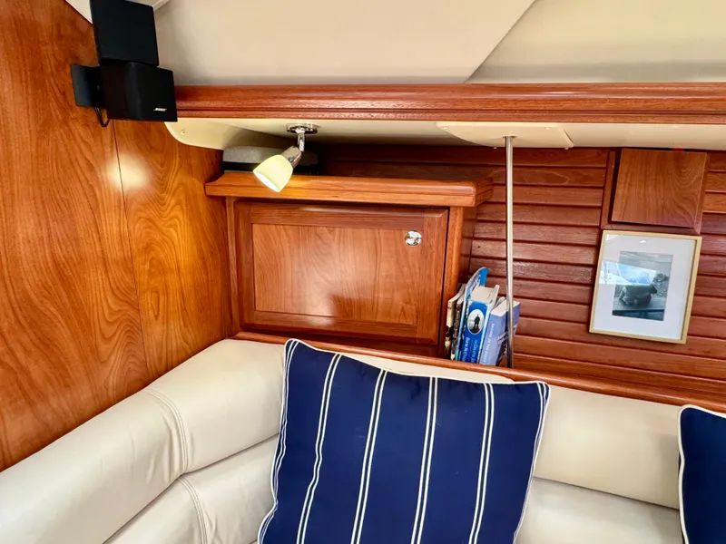 Slide: The Image of The interior cabin of a 2009 Hunter 50 Center Cockpit features a cozy seating area with blue cushions. - 47