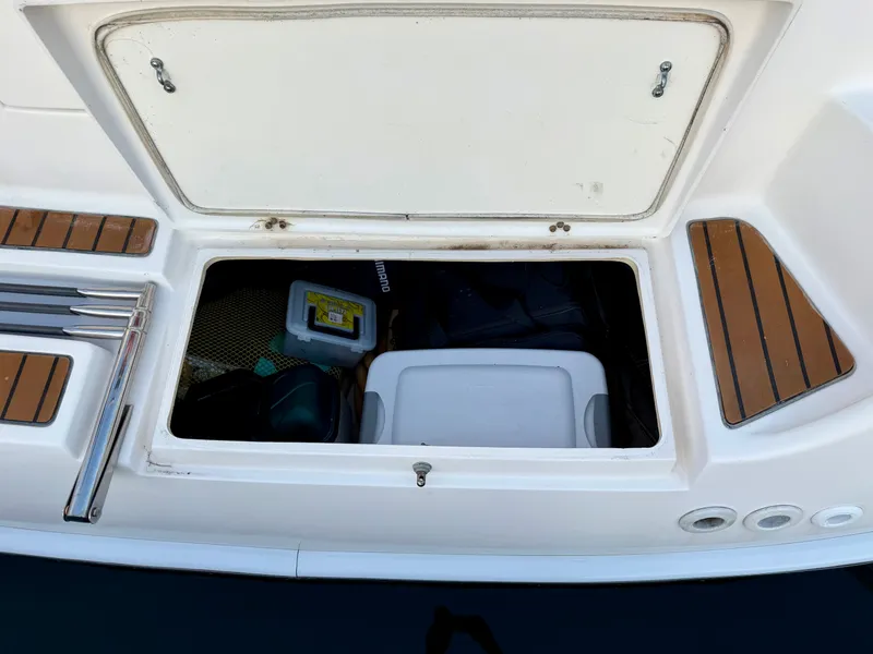 Slide: The Image of An open storage compartment on a boat with various items inside. - 34