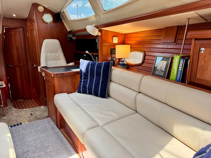 Slide: The Image of Interior of a 2009 Hunter 50 Center Cockpit yacht with beige sofa and wooden walls. - 44