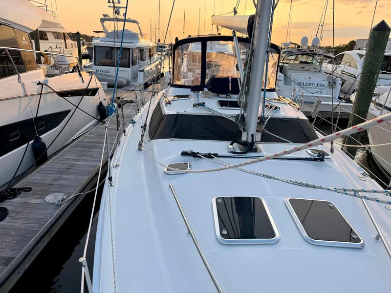 Slide: The Image of A 2009 Hunter 50 Center Cockpit sailboat docked in a marina at sunset. - 24