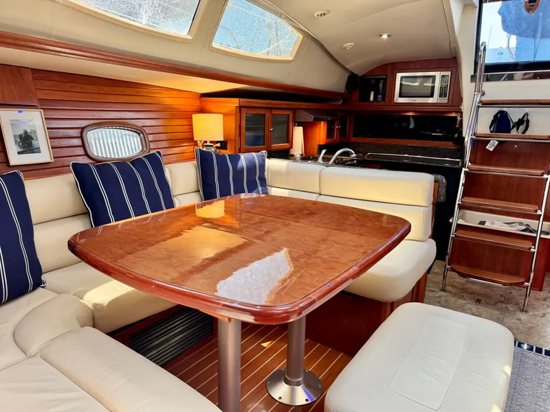 Slide: The Image of Interior of a 2009 Hunter 50 Center Cockpit with elegant wooden table and comfortable seating. - 46