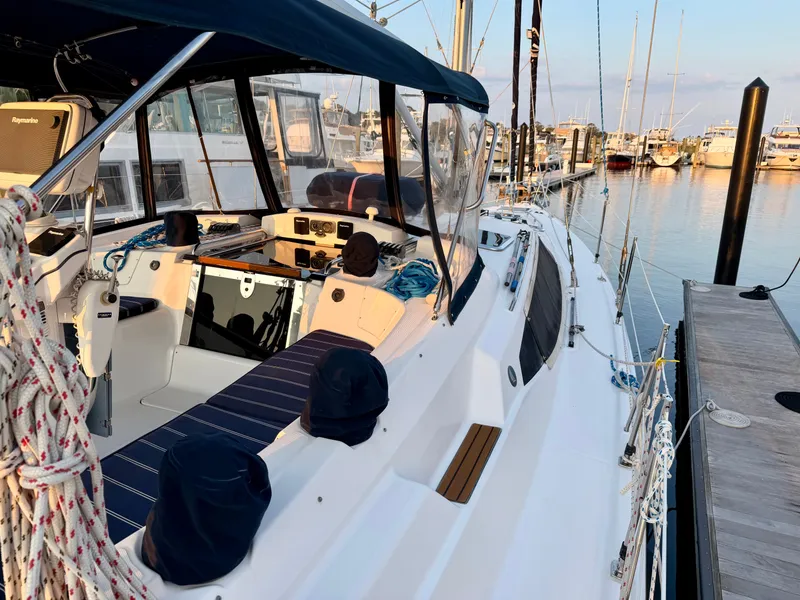 Slide: The Image of A 2009 Hunter 50 Center Cockpit sailboat docked at a tranquil marina. - 18