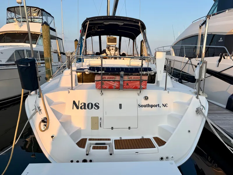 Slide: The Image of The image shows a 2009 Hunter 50 Center Cockpit sailboat docked, with life jackets on board. - 10