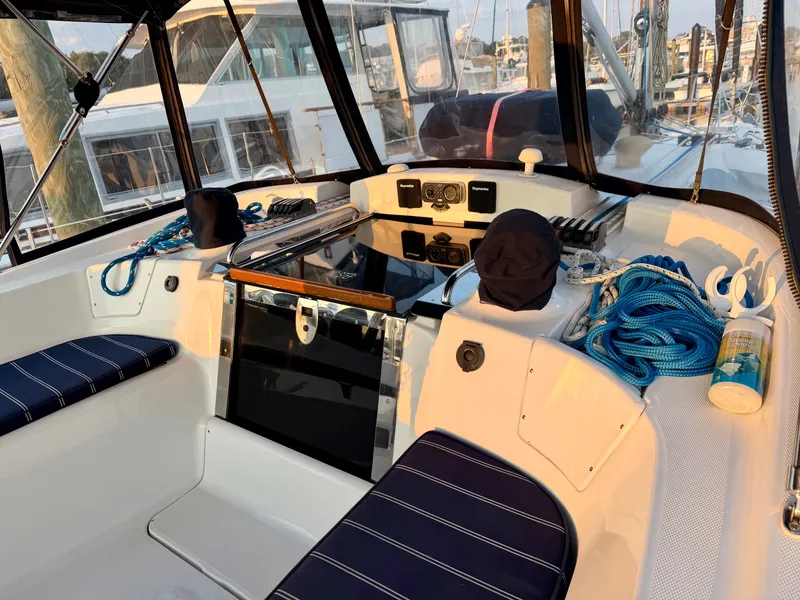 Slide: The Image of The cockpit of a 2009 Hunter 50 Center Cockpit with blue ropes and cushioned seating. - 23