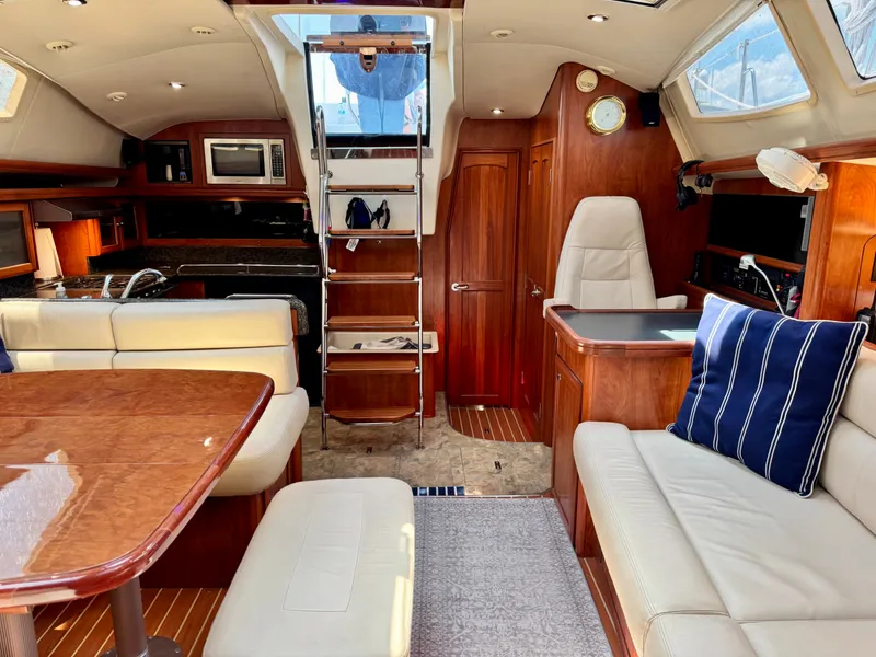 Slide: The Image of Interior of a 2009 Hunter 50 Center Cockpit yacht with elegant wood furnishings and comfortable seating. - 45