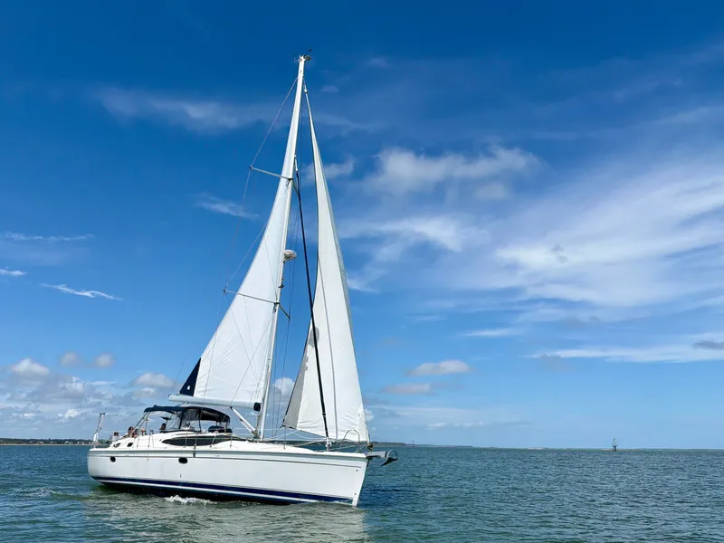Slide: The Image of 2009 Hunter 50 Center Cockpit sailboat on calm waters under a blue sky. - 7