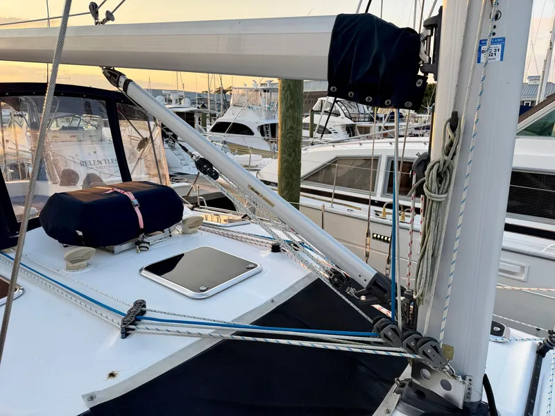 Slide: The Image of 2009 Hunter 50 Center Cockpit in a marina, featuring sailing equipment and surrounding boats. - 30