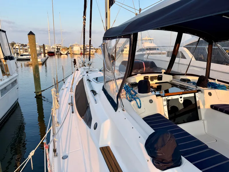 Slide: The Image of 2009 Hunter 50 Center Cockpit sailboat docked, featuring a spacious cockpit with blue cushions. - 22